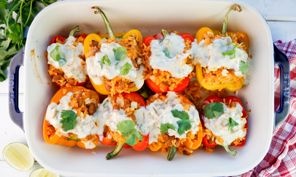 Rice and Bean Stuffed Bell Peppers with Green Chile Queso