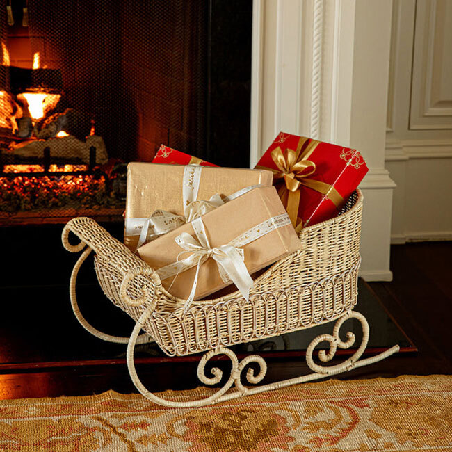 Juliska Provence Rattan Sleigh | Whitewash with wrapped packages by fireplace