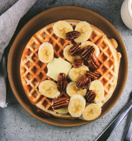 Greek Yogurt Waffles with Bananas, Candied Pecans, Maple Rum Syrup and Whipped Cream