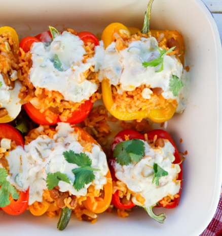 Rice and Bean Stuffed Bell Peppers with Green Chile Queso